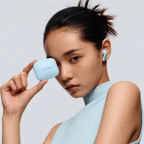 Model wearing ice-blue earbuds and holding a Nexscope charging case